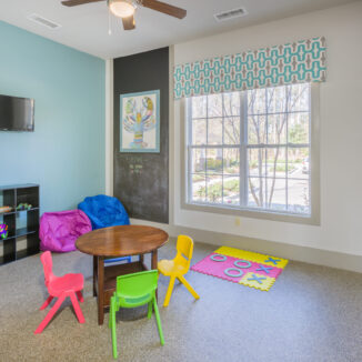 Kid's playroom with toys and a chalkboard